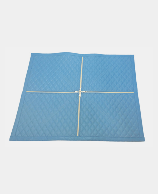 Blue quilted bedspread folded in half against a white background.