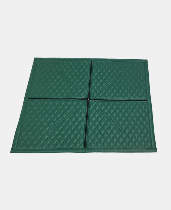 Four green, interlocking floor mats arranged in a square pattern.