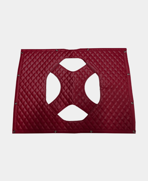 Red quilted leather piece with cut-out octagonal design and metal rivets on corners.