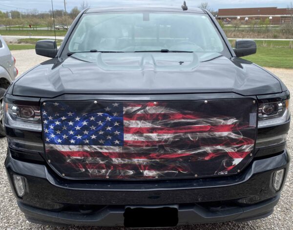A pickup truck with a Pickup Bug Screen: American Flag grille cover.