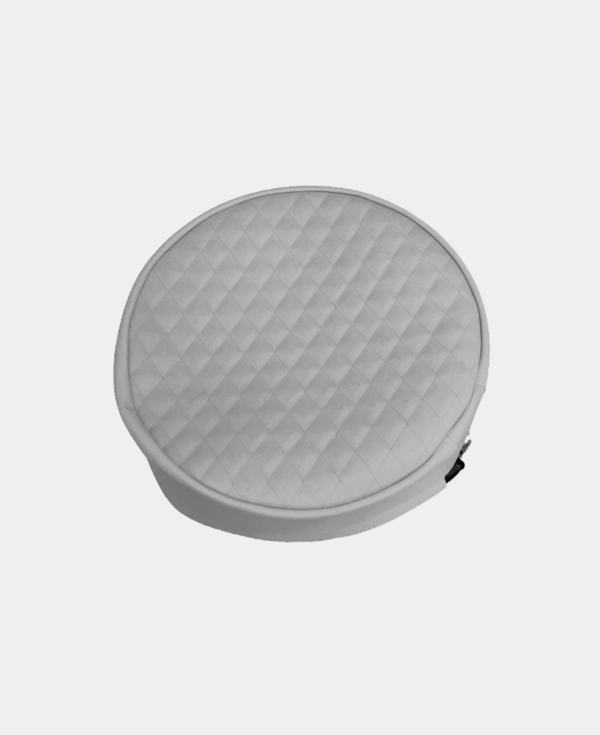 A round, quilted grey stool isolated on a white background.