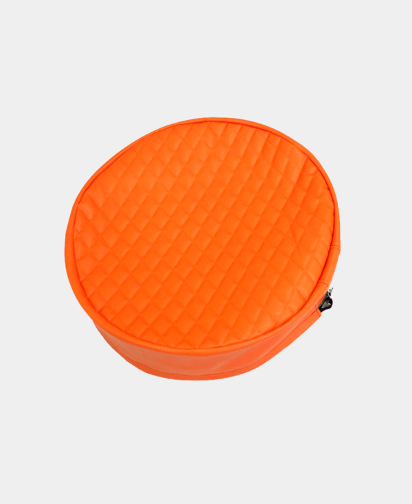 Orange round zippered case with quilted pattern on white background.