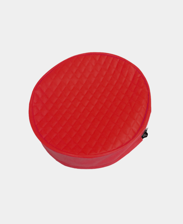 Red round zippered case with quilted pattern on white background.