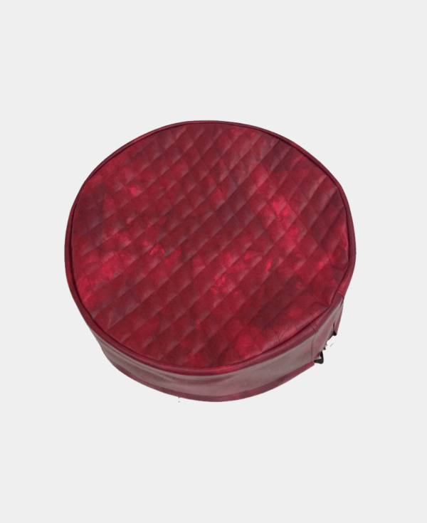 Circular red quilted case against a white background.