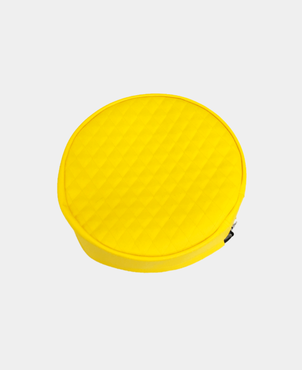 Yellow round quilted zippered case on a white background.