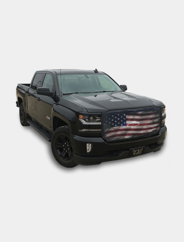A black pickup truck with an american flag design on the grille.