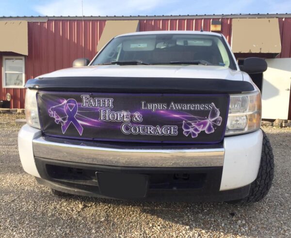 A truck with a Custom Bug Screen: Create Your Own banner displaying the words "faith, hope & courage" along with purple ribbons on its front grille.