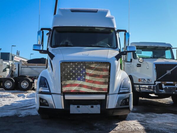 Old Glory - Bug Screen semi-truck parked in a lot with snow patches under a clear blue sky.