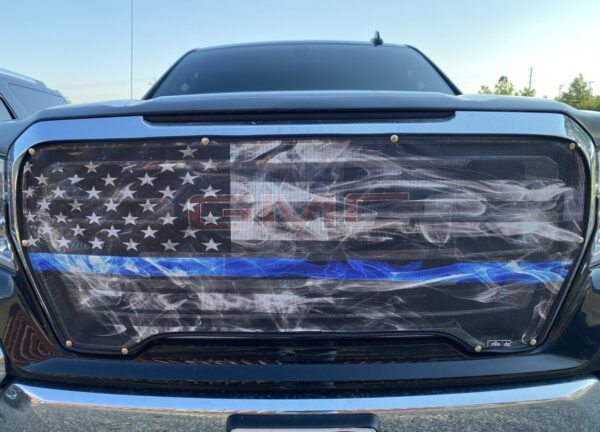 A Pickup/SUV/Van Bug Screen: Smokey Thin Blue Line with an american flag-themed grille, including a thin blue line design.