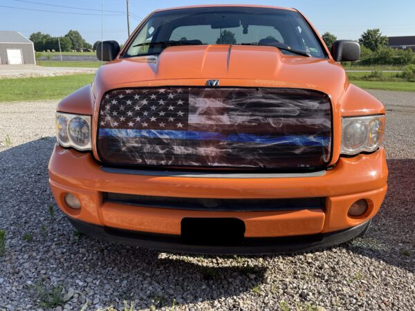 Orange pickup truck with a Pickup/SUV/Van Bug Screen: Smokey Thin Blue Line grille insert.