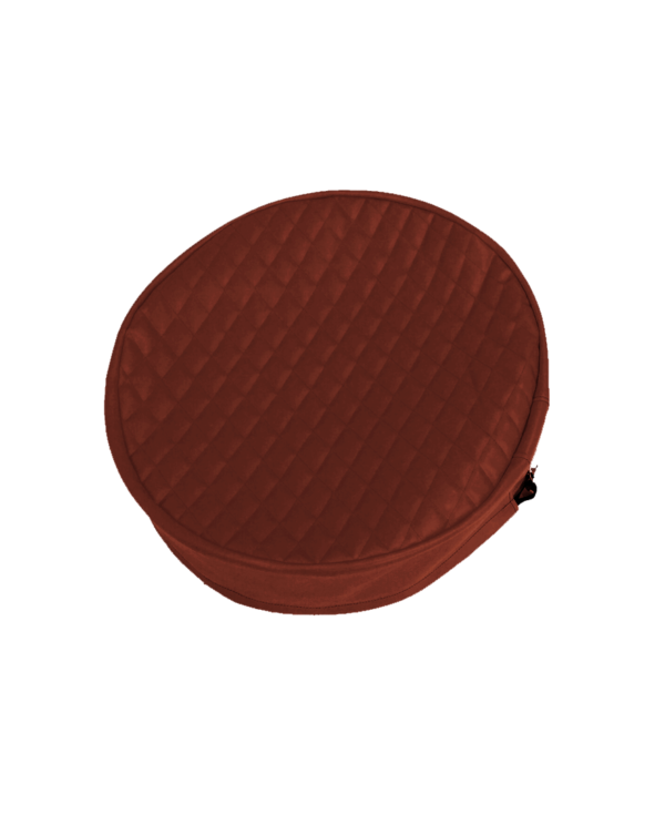 Round, brown, quilted fabric Fuel Tank End Cover on a green background.