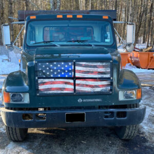 A truck with an american flag painted on the front.