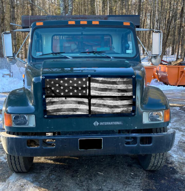A truck with an american flag painted on it's front.