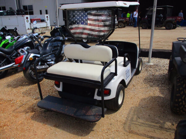 A UTV/Side by Side Rear Dust Screen with an american flag design on the roof parked among other vehicles.