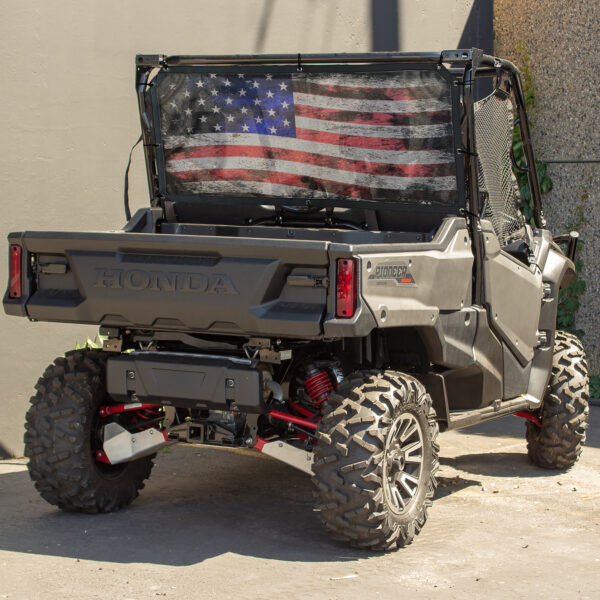 A UTV/Side by Side Rear Dust Screen with an american flag displayed in the cargo bed.