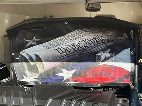 Custom rear window graphic on a vehicle depicting the united states flag and the constitution.