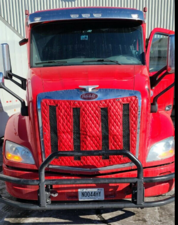 A red truck with the grill of it's hood up.